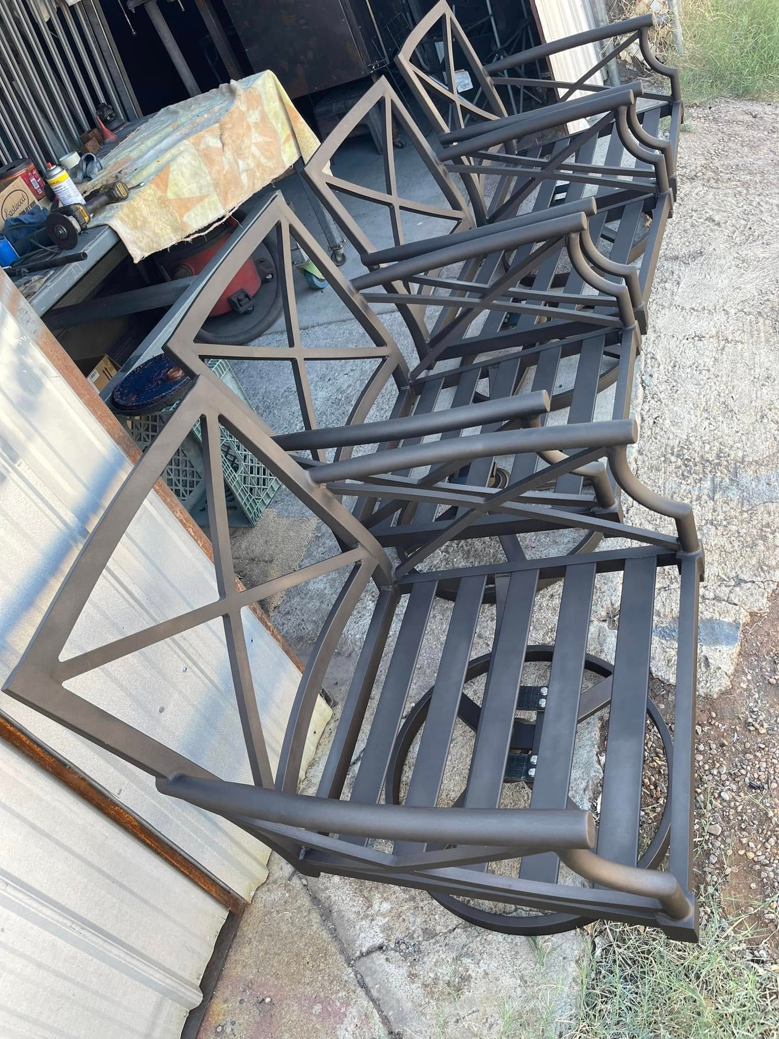 Bronze powder coated patio swivel chairs lined up outside the shop
